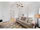 Spacious room area with hardwood floors, a beige couch and high ceilings featuring a decorative ceiling fan at 2442 Lower Union Hill Rd, Canton, GA 30115