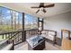 Cozy screened porch featuring an outdoor ceiling fan and a gas fire pit at 2442 Lower Union Hill Rd, Canton, GA 30115
