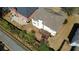 Aerial view of the home's backyard with a wooden deck, surrounded by green grass and trees at 2688 Autumn Ridge Ln, Lawrenceville, GA 30044