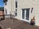 A cozy back deck featuring a swing and double doors to the home at 2688 Autumn Ridge Ln, Lawrenceville, GA 30044