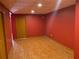 Finished basement area with ceramic tile floors and a red painted wall at 2688 Autumn Ridge Ln, Lawrenceville, GA 30044