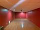 Finished basement area with ceramic tile floors and a red painted wall at 2688 Autumn Ridge Ln, Lawrenceville, GA 30044