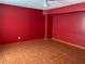 Finished basement area with ceramic tile floors and a red painted wall at 2688 Autumn Ridge Ln, Lawrenceville, GA 30044