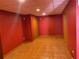 Finished basement area with ceramic tile floors and a red painted wall at 2688 Autumn Ridge Ln, Lawrenceville, GA 30044