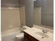 Bathroom featuring a tiled shower-tub, toilet, and a vanity with a sink and a dark wood cabinet at 2688 Autumn Ridge Ln, Lawrenceville, GA 30044