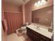 Cozy bathroom featuring a toilet with grab bars, vanity, and shower with peach fixtures at 2688 Autumn Ridge Ln, Lawrenceville, GA 30044