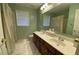 Green bathroom featuring a double vanity, toilet, and shower with bright natural light at 2688 Autumn Ridge Ln, Lawrenceville, GA 30044