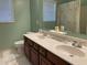 Green bathroom featuring a double vanity, toilet, and shower with bright natural light at 2688 Autumn Ridge Ln, Lawrenceville, GA 30044