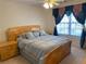 Neutral bedroom featuring a bed, wooden furniture, curtains, and neutral paint scheme at 2688 Autumn Ridge Ln, Lawrenceville, GA 30044
