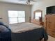 This bedroom features carpeted floors, a ceiling fan, and a wooden dresser at 2688 Autumn Ridge Ln, Lawrenceville, GA 30044