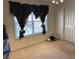 Bedroom with neutral carpet and large window with decorative curtains; great natural light at 2688 Autumn Ridge Ln, Lawrenceville, GA 30044