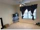Bedroom with neutral carpet and large window with decorative curtains; great natural light at 2688 Autumn Ridge Ln, Lawrenceville, GA 30044
