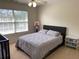 Neutral bedroom featuring a bed, ceiling fan, natural light from the window, and basketball hoop at 2688 Autumn Ridge Ln, Lawrenceville, GA 30044