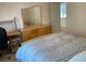 Bright bedroom featuring a mirrored dresser, side desk, and a comfortable bed with blue accents at 2688 Autumn Ridge Ln, Lawrenceville, GA 30044