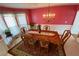 Dining room with chandelier, window, and long wood table with seating at 2688 Autumn Ridge Ln, Lawrenceville, GA 30044