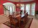 Dining room with ornate table, chandelier, rug, and archway at 2688 Autumn Ridge Ln, Lawrenceville, GA 30044