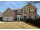 Charming two-story brick home featuring a two-car garage, large windows, and a well-maintained front lawn at 2688 Autumn Ridge Ln, Lawrenceville, GA 30044