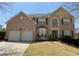 Charming two-story brick home with a well-manicured lawn, attached two car garage, and inviting front entrance at 2688 Autumn Ridge Ln, Lawrenceville, GA 30044