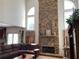 Living room with stone fireplace feature and lots of natural light from large windows at 2688 Autumn Ridge Ln, Lawrenceville, GA 30044