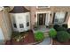 Close-up view of the home's front entrance, including a bay window and beautifully landscaped garden beds at 2688 Autumn Ridge Ln, Lawrenceville, GA 30044