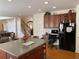 Spacious kitchen with center island, stainless steel appliances, and a view of the staircase at 2688 Autumn Ridge Ln, Lawrenceville, GA 30044