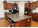 Lovely kitchen with island and stainless appliances plus dark wood cabinets at 2688 Autumn Ridge Ln, Lawrenceville, GA 30044