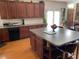 Well-equipped kitchen with wooden cabinets, counter space, and a view into an adjacent sitting area at 2688 Autumn Ridge Ln, Lawrenceville, GA 30044