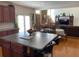 Bright open concept kitchen with hardwood floors, a center island, and views into the adjacent living area at 2688 Autumn Ridge Ln, Lawrenceville, GA 30044