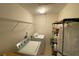 Bright laundry room with modern appliances and shelving for ample storage at 2688 Autumn Ridge Ln, Lawrenceville, GA 30044