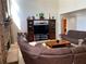 Bright living room featuring hardwood floors and a fireplace with stone facade at 2688 Autumn Ridge Ln, Lawrenceville, GA 30044