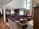 Open-concept living room features a large sectional sofa, stone fireplace, and lots of natural light at 2688 Autumn Ridge Ln, Lawrenceville, GA 30044