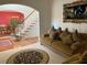 Living room with two sofas, rug, and view of stairs and dining room at 2688 Autumn Ridge Ln, Lawrenceville, GA 30044