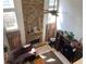 Upstairs view of living room with stone fireplace, ceiling fan, and natural light at 2688 Autumn Ridge Ln, Lawrenceville, GA 30044