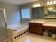 Well-lit main bathroom with a separate shower, soaking tub, and dual vanity sinks at 2688 Autumn Ridge Ln, Lawrenceville, GA 30044