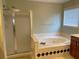 This is a bathroom featuring a separate glass shower and soaking tub at 2688 Autumn Ridge Ln, Lawrenceville, GA 30044
