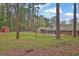 Expansive backyard featuring a storage shed and mature trees, offering privacy and space at 3441 Palace Ct, Tucker, GA 30084