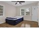 Bedroom with hardwood floors, a ceiling fan, and two windows for natural light at 3441 Palace Ct, Tucker, GA 30084