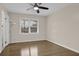 Bedroom features hardwood floors, ceiling fan, a window for natural light, and baseboard trim at 3441 Palace Ct, Tucker, GA 30084