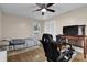 Bedroom features ceiling fan, gaming set up, closet with sliding doors, and hardwood flooring at 3441 Palace Ct, Tucker, GA 30084