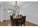 Traditional dining room with wood floors, crown moulding and a unique stained glass chandelier at 3441 Palace Ct, Tucker, GA 30084