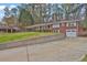 Well-maintained home with a two-car garage, a front porch, and a concrete retaining wall at 3441 Palace Ct, Tucker, GA 30084
