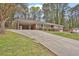 Lovely single-story brick home featuring a covered carport, a long driveway, and mature trees at 3441 Palace Ct, Tucker, GA 30084