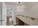 Hallway featuring tile-topped vanity space, hardwood floors, and white trim at 3441 Palace Ct, Tucker, GA 30084