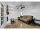 Bright living room with hardwood floors, a ceiling fan, a brick fireplace, and a comfortable sofa at 3441 Palace Ct, Tucker, GA 30084