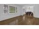 Bright living area with hardwood floors, large windows, and a view into the dining room at 3441 Palace Ct, Tucker, GA 30084