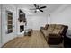 Cozy living room with hardwood floors, a ceiling fan, a brick fireplace, and a comfy sofa at 3441 Palace Ct, Tucker, GA 30084