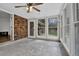 Beautiful sunroom featuring brick accent wall, tile floors, and lots of natural light at 3441 Palace Ct, Tucker, GA 30084