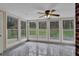 Bright sunroom with tile floors, ceiling fan, and large windows overlooking the backyard at 3441 Palace Ct, Tucker, GA 30084