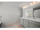 Bathroom features a double vanity, a large mirror and neutral tiling at 7083 Gladstone Cir, Stonecrest, GA 30038
