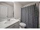 A clean bathroom featuring a shower with patterned curtain and a vanity with white countertop at 7083 Gladstone Cir, Stonecrest, GA 30038